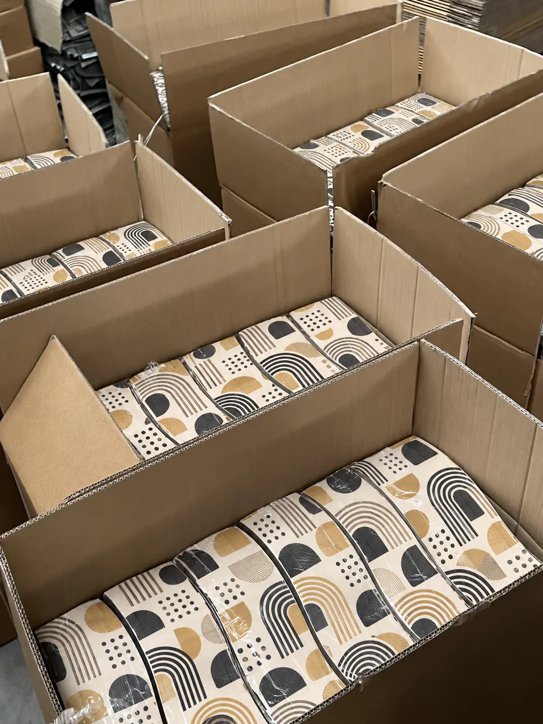 Patterned cat scratchers nested inside export cartons.