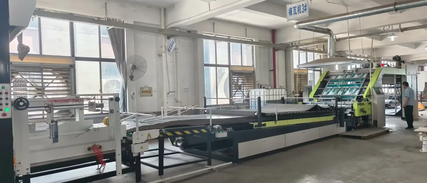 Full-length folder-gluer in the daylight workshop, an in-house line for folded corrugated forms.