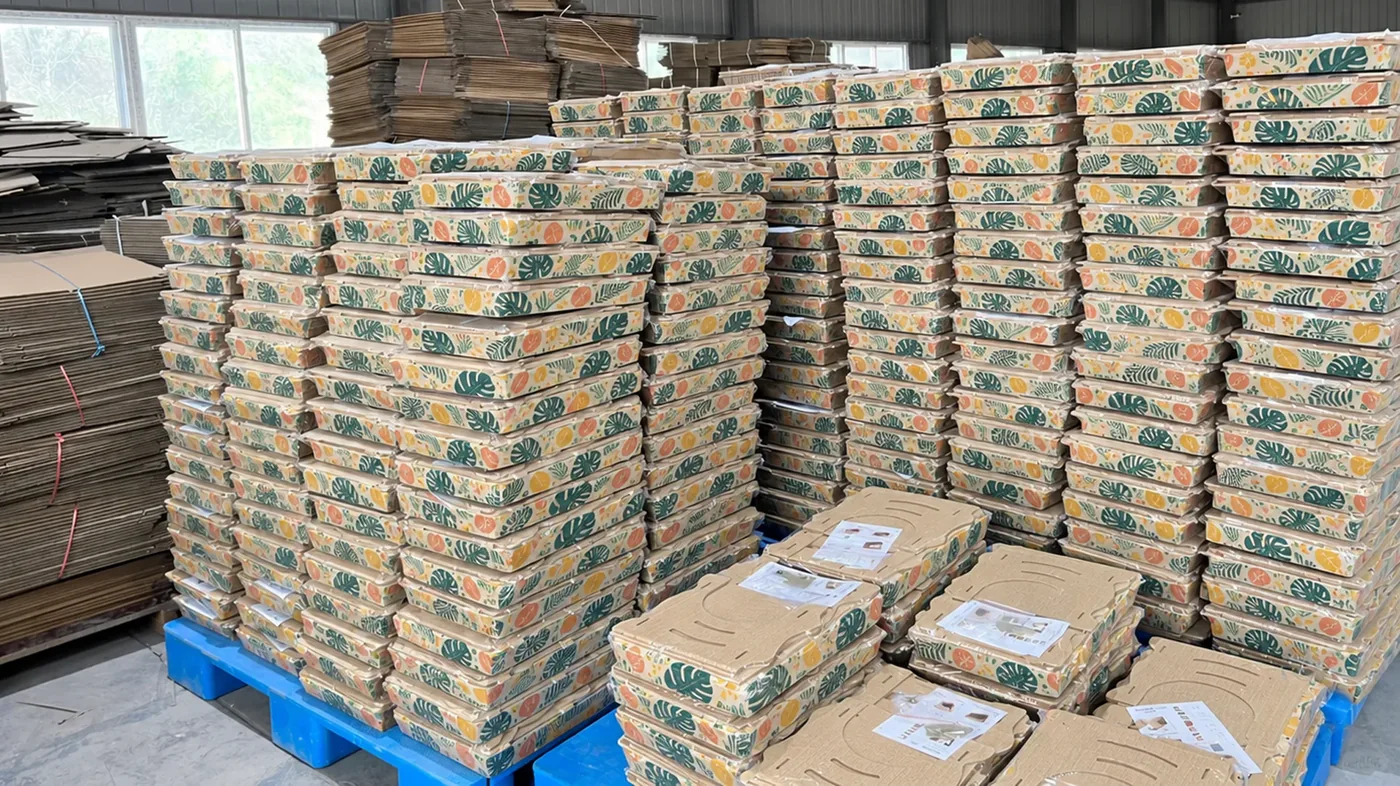 Finished scratcher cartons stacked for dispatch, pallet after pallet of retail-ready cat scratchers.