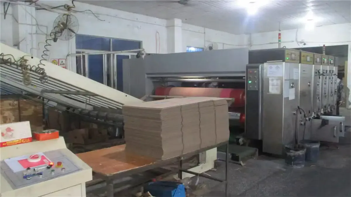 Freshly printed corrugated sheets stacked at press delivery, ready for die-cutting into cat scratchers.