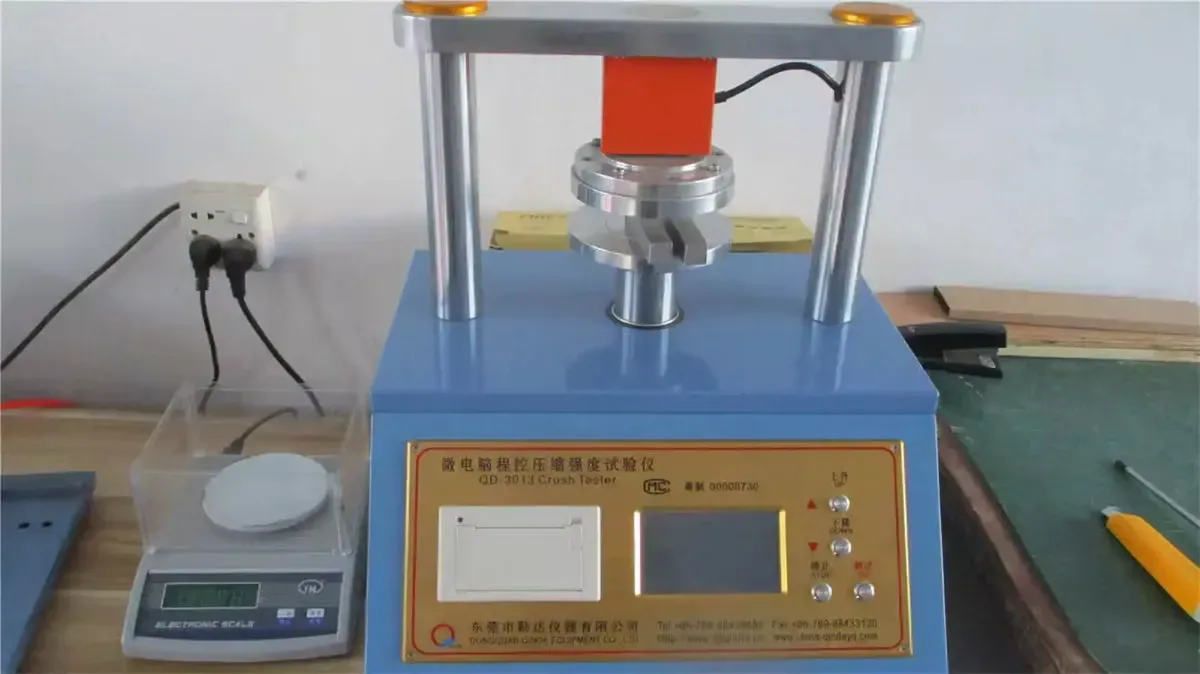 Corrugated board strength being checked on an in-house crush tester.
