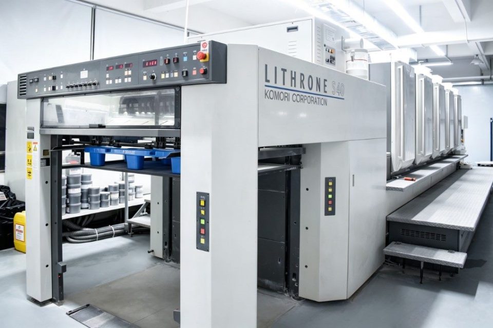 The offset press line printing branded artwork on sheets for corrugated cat scratchers.